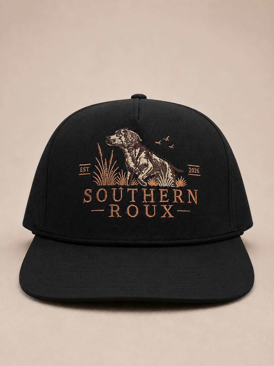 Black five-panel Southern Roux cap with embroidered dog-and-marsh logo.