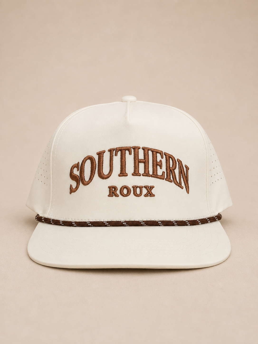 White five-panel Southern Roux cap with arched embroidery and patterned rope detail.