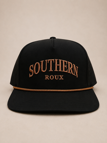 Black five-panel Southern Roux cap with arched embroidery and tan rope detail.