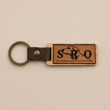 Brown leather SRO key chain with metal ring and rectangular logo patch.