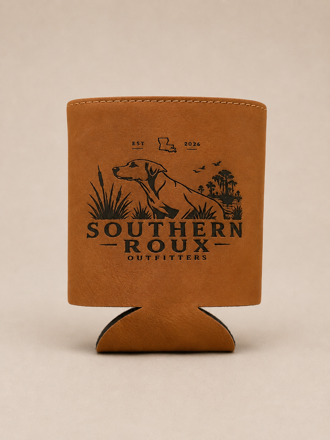 Brown leather koozie with the Southern Roux dog-and-marsh logo.