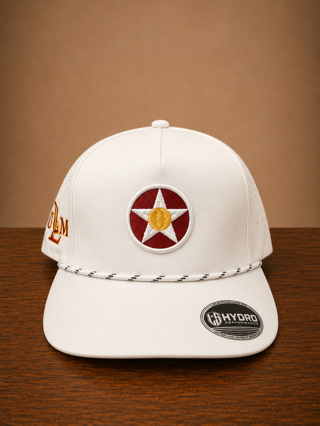 White rope cap with a circular star design on front and ULM embroidery on the side.
