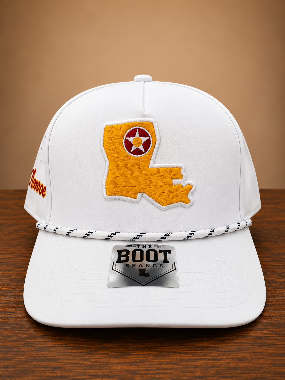 White rope cap with Louisiana state embroidery on front and Monroe script embroidery on the side.
