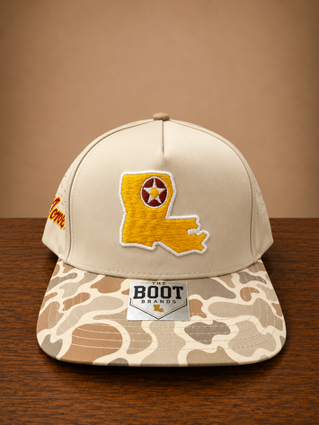 Duck marsh camo brim cap with Louisiana state embroidery on front and Monroe script embroidery on the side.
