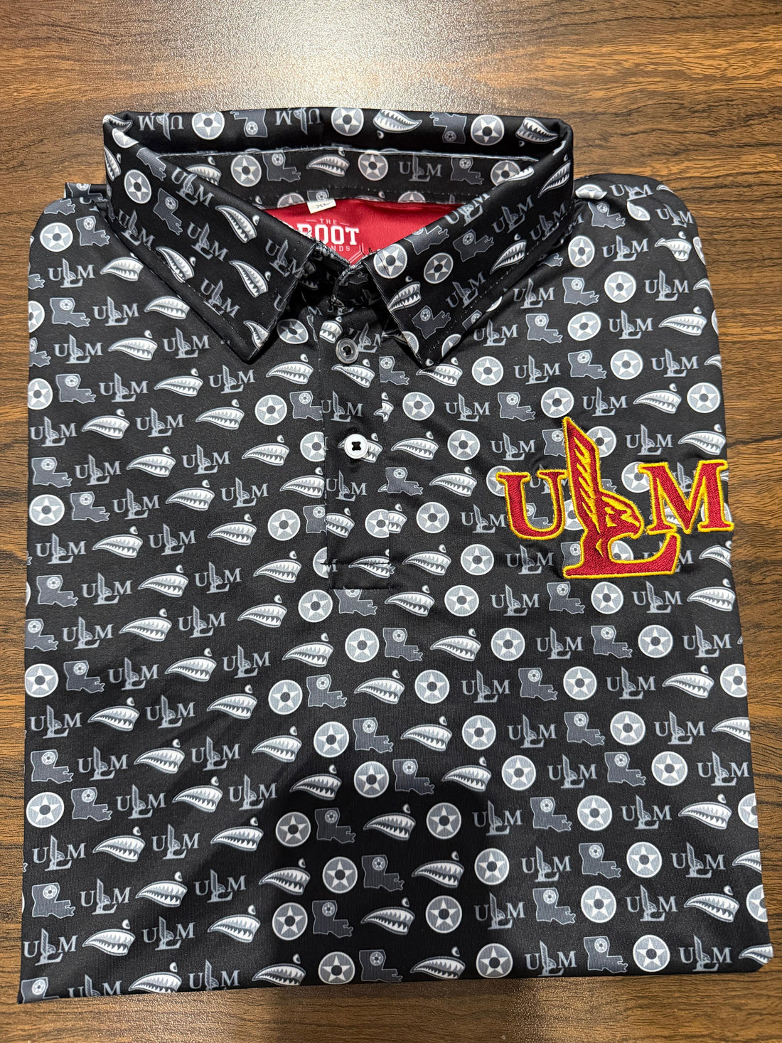 Black ULM Athletic Dri Fit Polo with repeating ULM pattern and embroidered ULM chest mark.