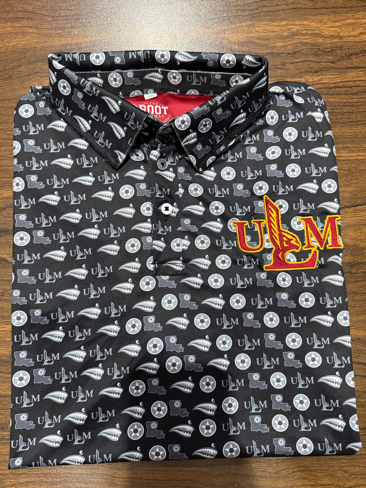 Black ULM Athletic Dri Fit Polo with repeating ULM pattern and embroidered ULM chest mark.